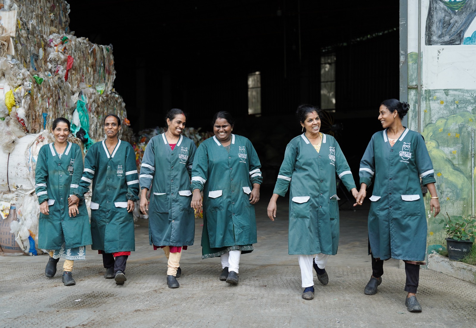Women waste workers walking